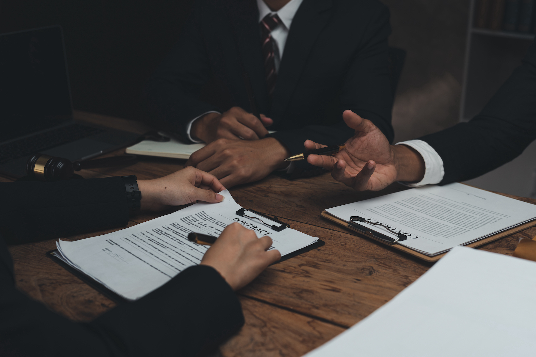 Lawyer discussing with client about contract, agreement, legal guideline, lawsuit. Lawyer work on documents in the office.