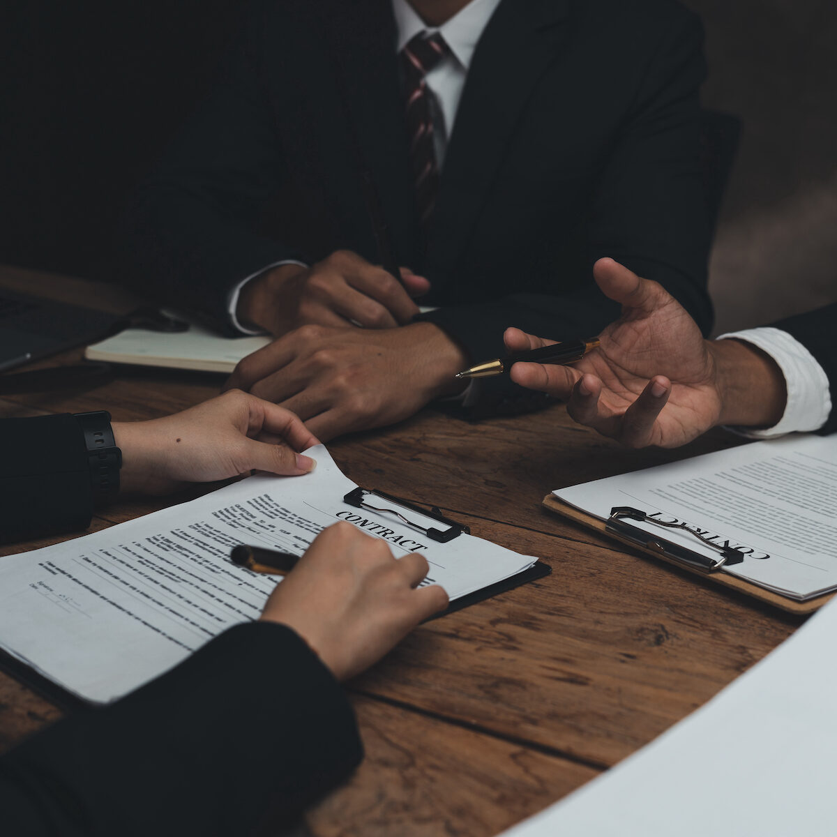 Lawyer discussing with client about contract, agreement, legal guideline, lawsuit. Lawyer work on documents in the office.